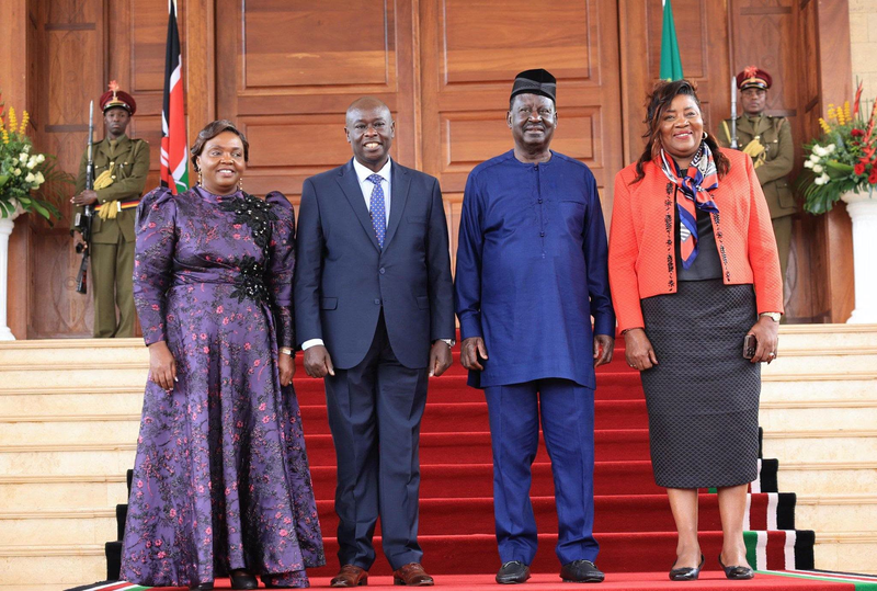 Rigathi Gachagua poses for a photo with late Raila Odinga and Ida Odinga at a past event.